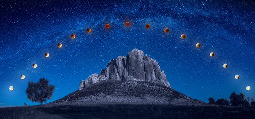 Track of full blood moon eclipse above the mountain - obrazy, fototapety, plakaty