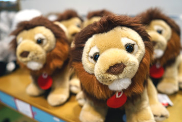 Soft toys lion cubs for children on the counter of the store.
