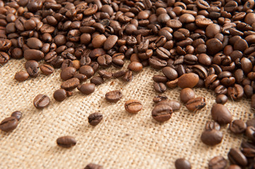 Abstract background with coffee beans on the background of sacking