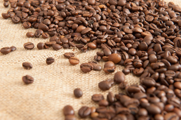 Abstract background with coffee beans on the background of sacking