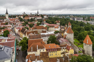 Breathtaking aerial view of the medieval towers and the old town of Tallinn, Estonia, from the top of the St. Olav's Church bell tower - obrazy, fototapety, plakaty
