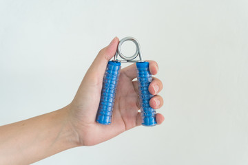 Hand holding gripper on white background