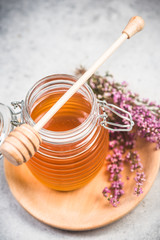 Jar with honey and fresh flowers