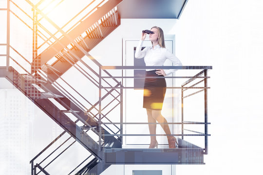 Woman With Binoculars On Fire Exit Stairs