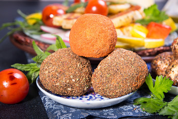 Cheese belper knolle in spices red and black pepper decorated with mint.