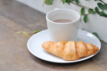 croissant and hot cocoa on the table