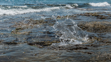 Sea water splashing on the rock