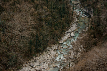 Beautiful top view of azure forest river flowing among rocks in Martvili canyon