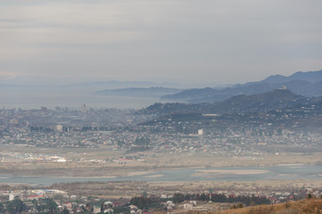 Autumn georgian landscape of little Batumi town on the background of mountains