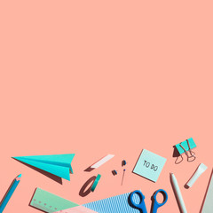 School supplies on a pink background.