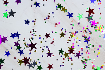 festive background with sequins in the shape of stars