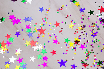festive background with sequins in the shape of stars