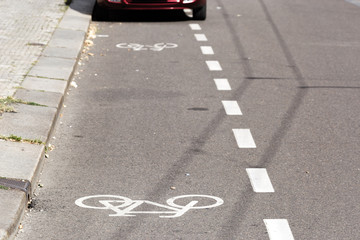 Partial view of a parked car on a bike path