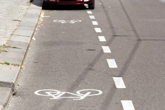 Partial view of a parked car on a bike path