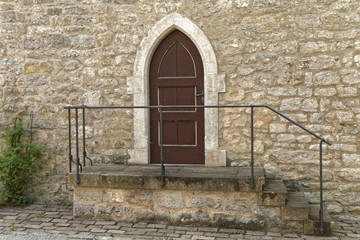 Old, wooden door with stone stairs.