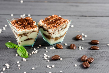 sweet fruit desserts in glasses on the wooden background
