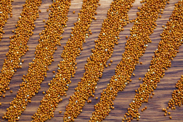 Millet, cereals on a wooden background, large plan, top-view