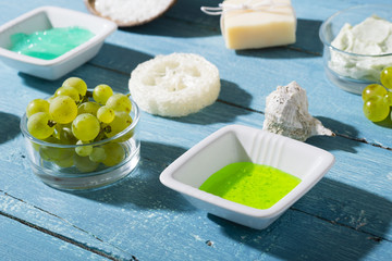 beauty product samples from grape seed ingredient, blue wooden table background