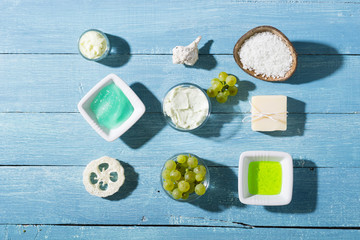 beauty product samples from grape seed ingredient, blue wooden table background