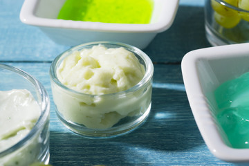 beauty product samples from grape seed ingredient, blue wooden table background