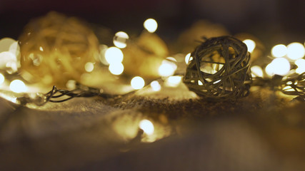 Close-up christmas garland and handmade balls on a playd with golden lights. Christmas concept....