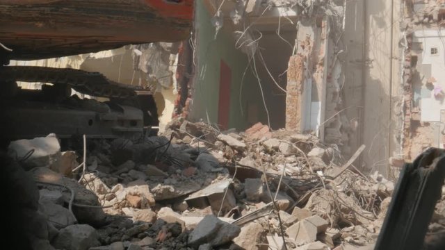 demolition of the building, demolition work, excavator at work, tracks