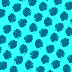 Tropical palm monstera leaves lies on a pastel colored paper. Nature summer concept pattern. Flat...