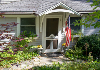 Fototapeta na wymiar Cottage with American flag in New England