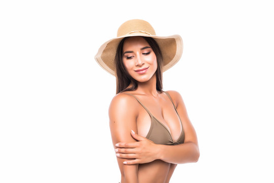 Portrait of pretty sexy woman in straw hat isolated on white background. Enjoying her summer vacations.