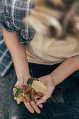 Woman holding autumn leaves in hand