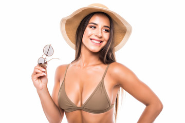 Portrait of woman wearing bikini, hat and sunglasses, isolated on white background. Concept of summer holidays and traveling