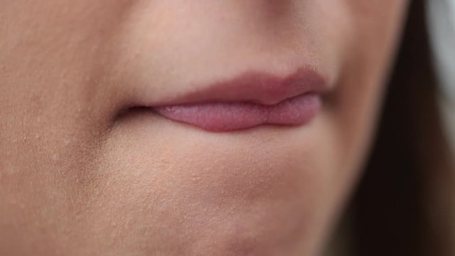 Macro close-up of girl mouth biting lips