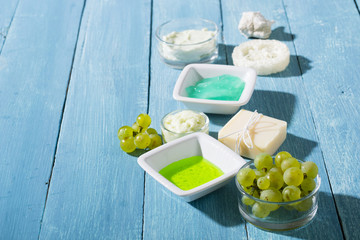 beauty products from grape seed ingredient, blue wooden table background