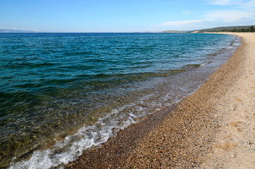The picturesque long sandy beach. Olkhon Island. Lake Baikal