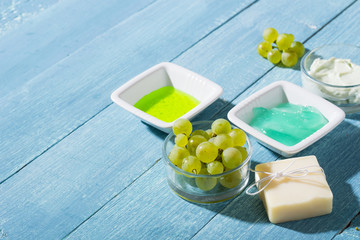 beauty products from grape seed ingredient, blue wooden table background