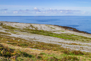 Fanore beach in Burren mountain with Aran Islands in background