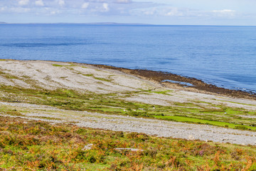 Fanore beach in Burren mountain with Aran Islands in background