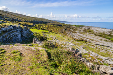 Fanore beach in Burren mountain with farm and rocks