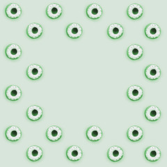 Many small plastic donuts lies on a pastel colorful background. Flat lay minimal pattern. Top view