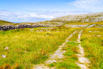 Rocks and trail over mountain in Burren way trail