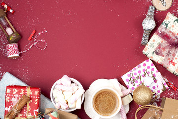 A cup of fragrant coffee and New Year decor on a red background. gifts and syootrizy for Christmas. Top view. Frame. Copy space.