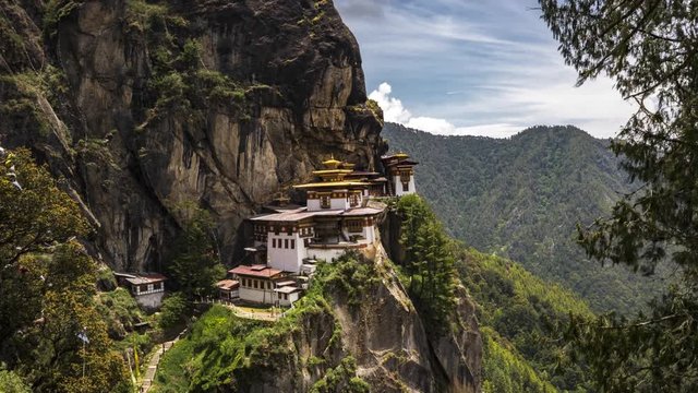 4K Timelapse movie video film of Taktshang Goemba or Tiger's nest Temple the beautiful buddhist temple.The most sacred place in Bhutan is located on the high cliff mountain with sky of Paro valley