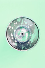 Single used spray can for graffiti drawing lies on a pastel colored backgroung. Street art painting...