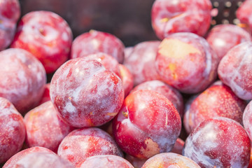 Ripe plums on the counter in the store. fresh red plums. On the counter of a vegetable store