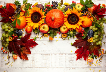 Thanksgiving background with autumn pumpkins, fruits and flowers