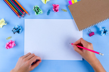 Idea concept. Сolorful crumpled paper balls and school supplies on a blue background. New idea concept. Copy space 