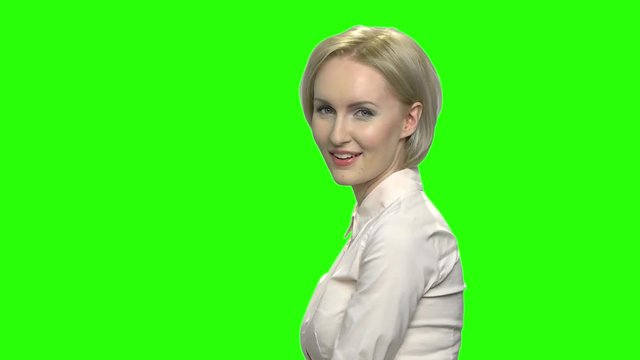 Smiling sexy mature woman in office shirt flirting. Slow motion. Green hromakey background for keying.
