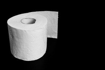 white toilet paper roll on black background