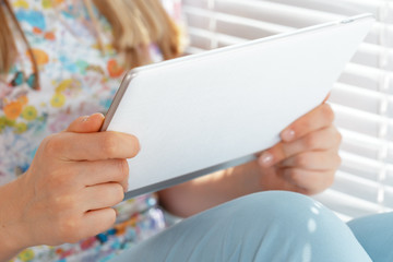 woman holding digital tablet, closeup