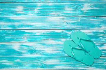 flip flops on blue wooden floor.